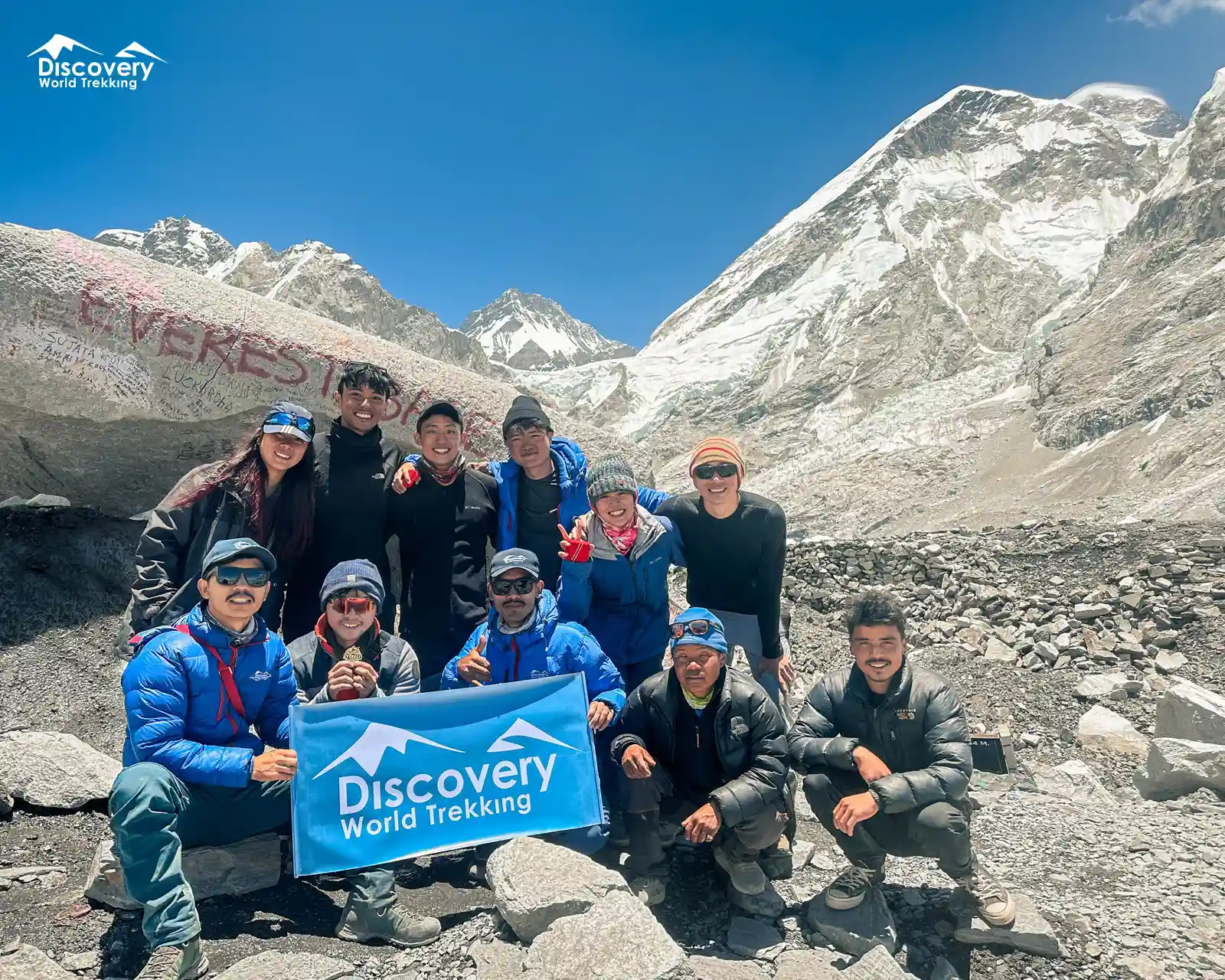 Excited group photo at Everest Base Camp, celebrating the EBC Trek achievement.