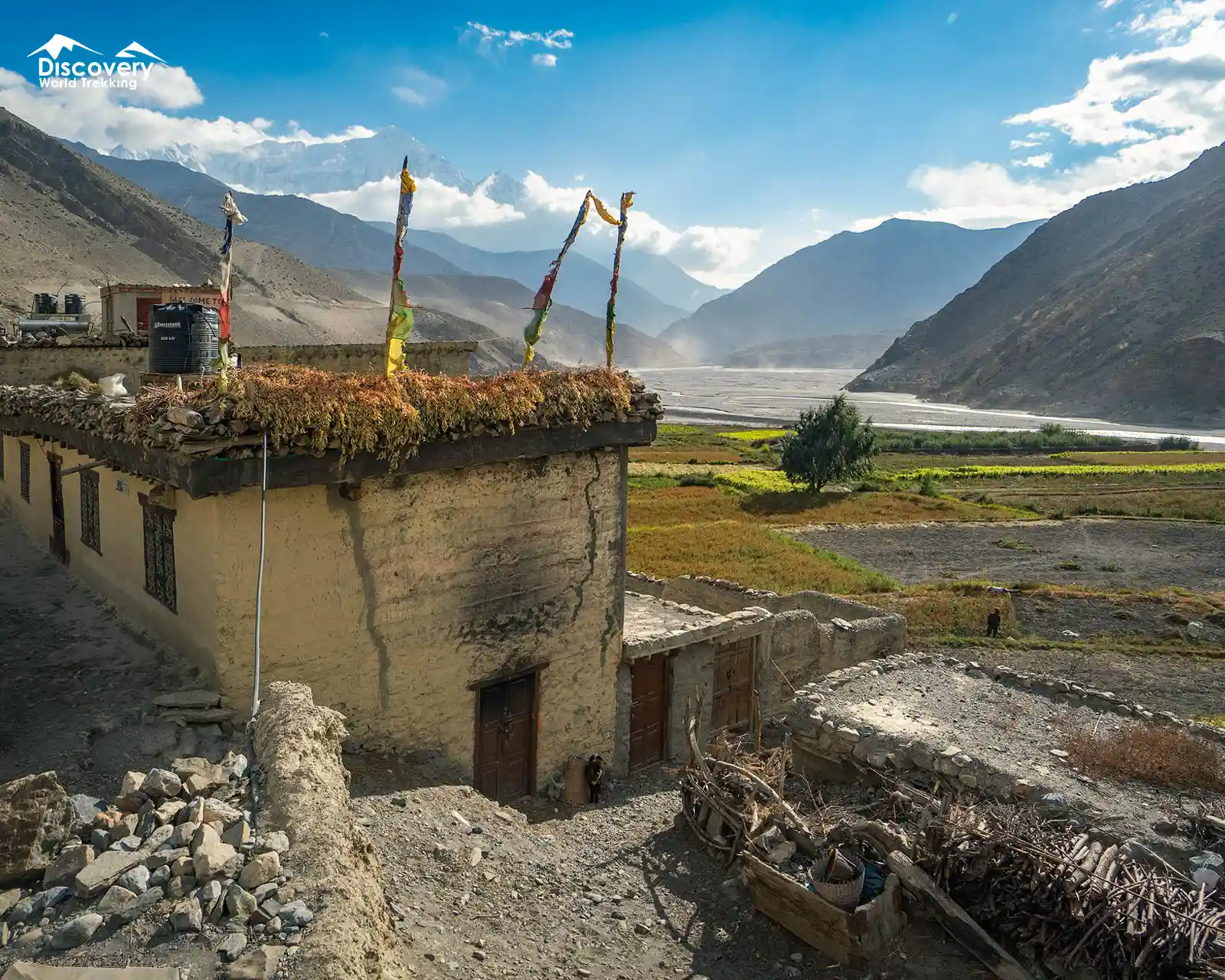 Stone house with prayer flags overlooking Chusang.